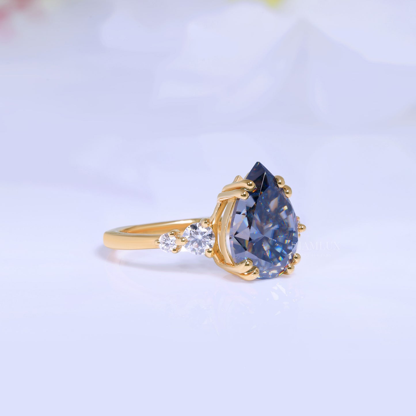 Yellow Gold Pear Shaped Dark Blue Gemstone Ring with Round Accent Stones Diamlux Fine Jewelry