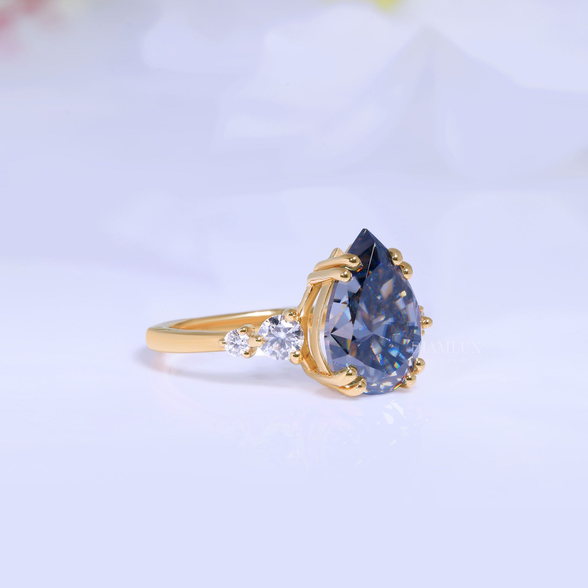 Yellow Gold Pear Shaped Dark Blue Gemstone Ring with Round Accent Stones Diamlux Fine Jewelry