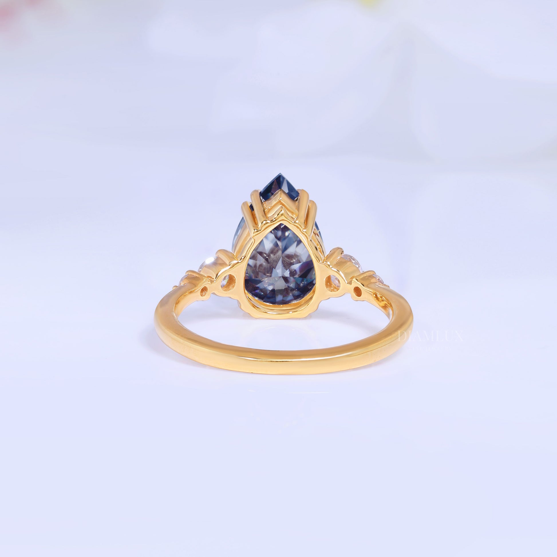 Yellow Gold Pear Shaped Dark Blue Gemstone Ring with Round Accent Stones Diamlux Fine Jewelry