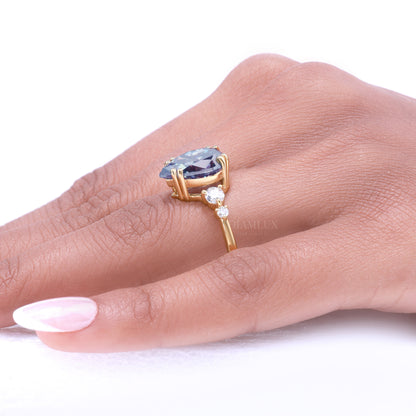 Yellow Gold Pear Shaped Dark Blue Gemstone Ring with Round Accent Stones Diamlux Fine Jewelry